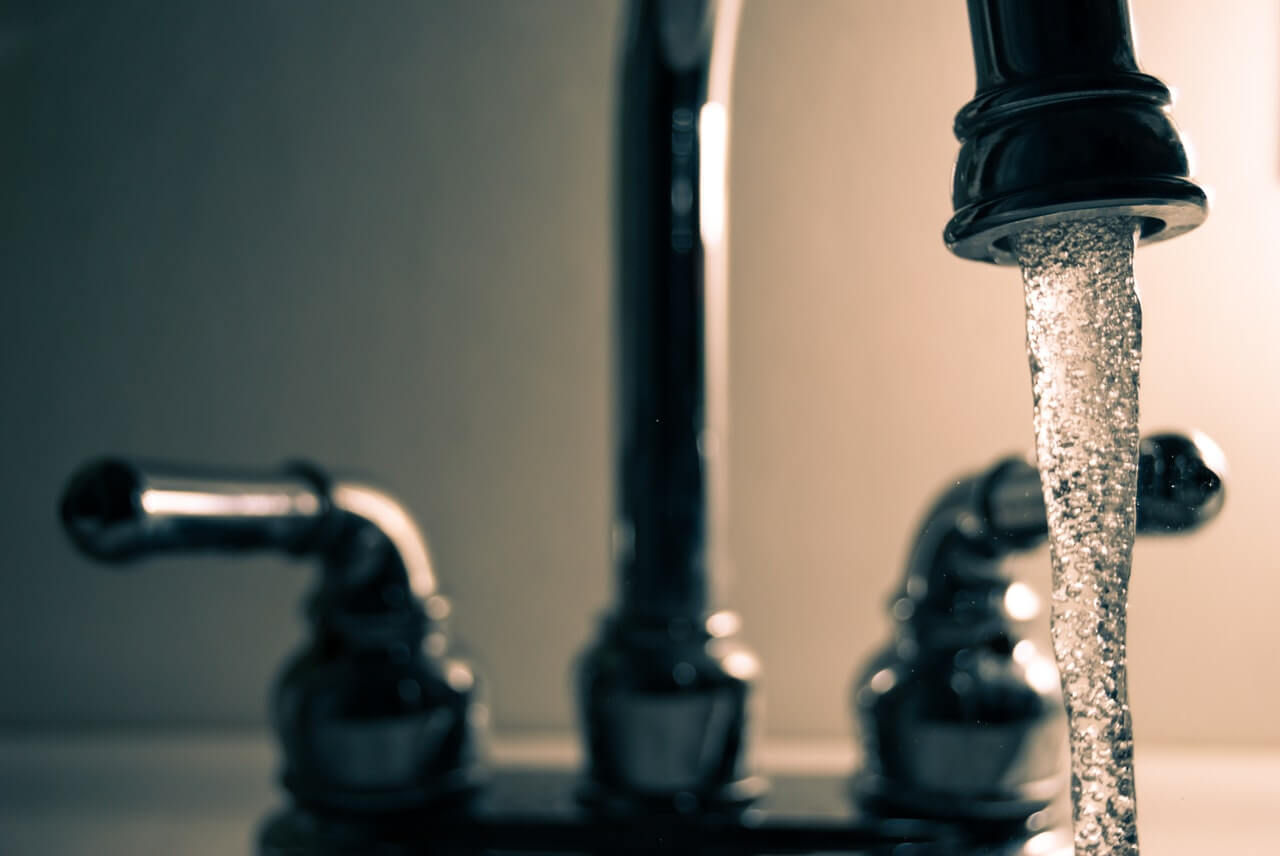 water uit een kraan om aan te duiden hoe veel liter water per dag gezond is